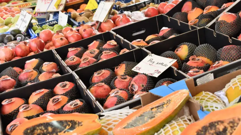 Fruta fresca con carteles de precio en un puesto de mercado